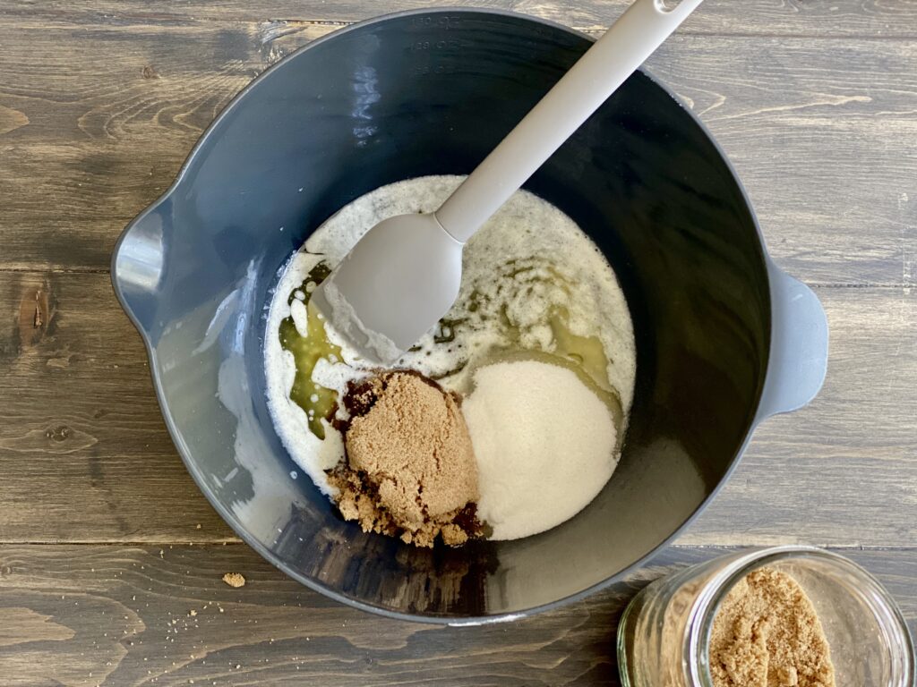 Brown sugar, sugar and butter in a mixing bowl waiting to be mixed