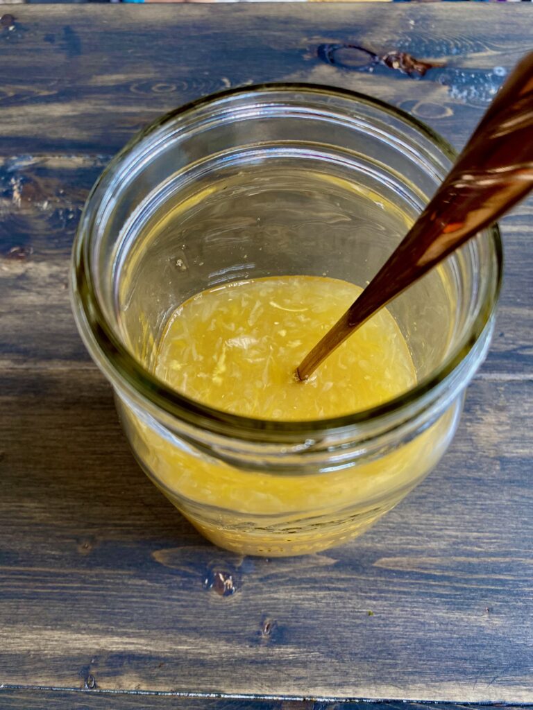 Orange juice and lime juice mixed together in a jar.