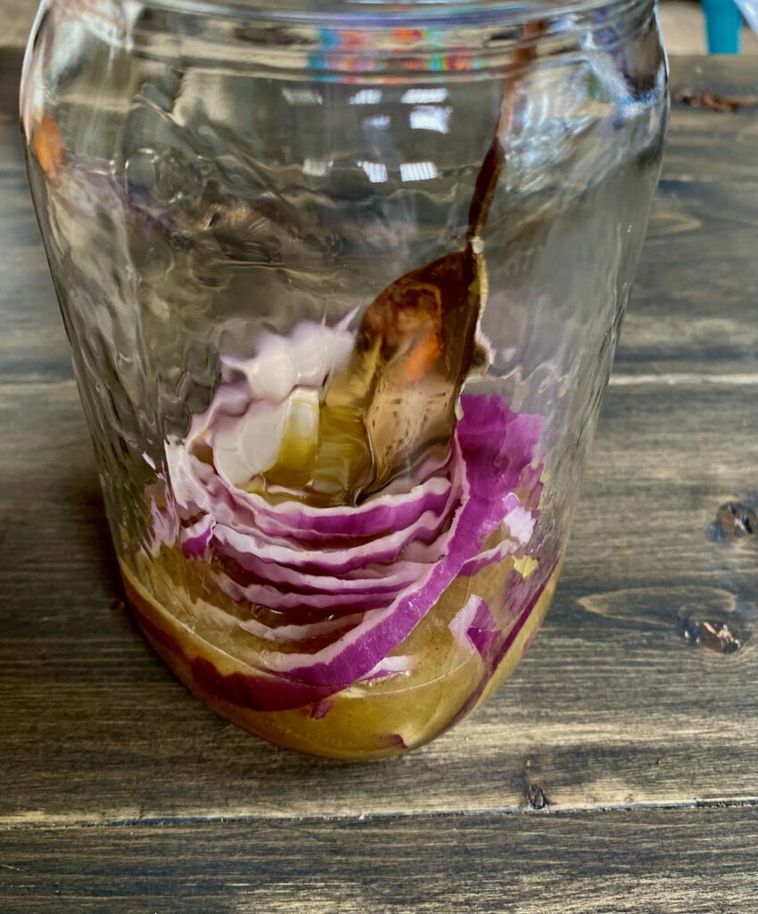 Red onion and brine in a mason jar.