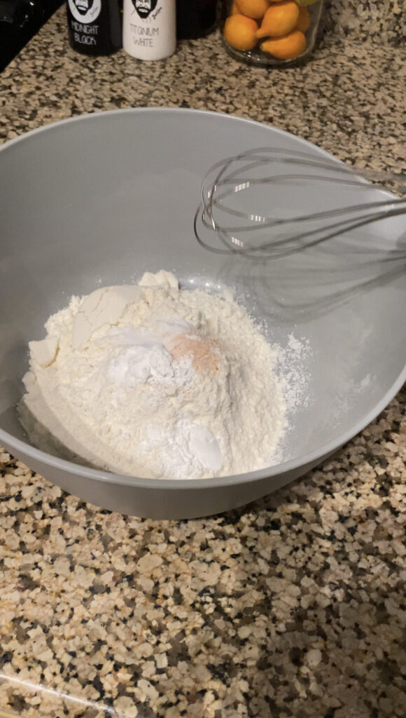 Whisking flour, baking soda, baking powder, and salt.