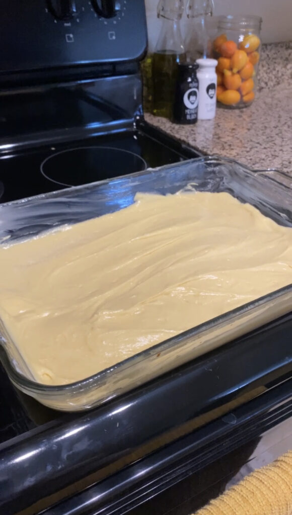 Batter spread evenly through glass dish ready to be baked.