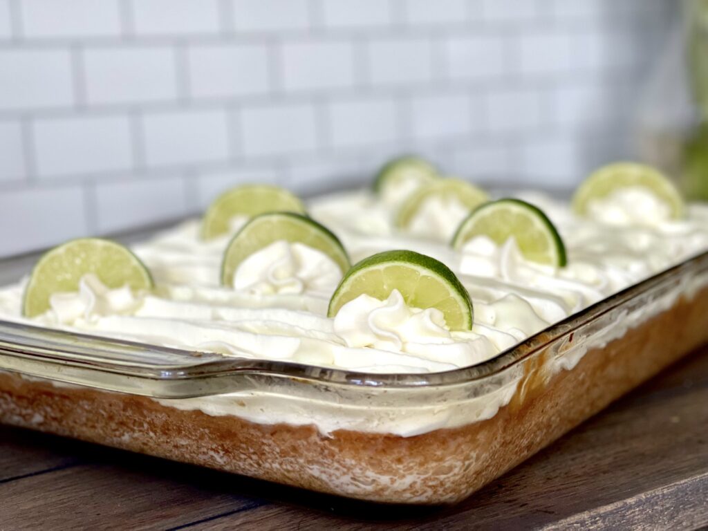 Tres Leche Cake with Key lime topping decorated with sliced limes.