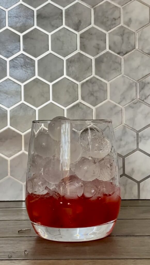 Limeade, Cherry Syrup, and ice to the top of the glass.