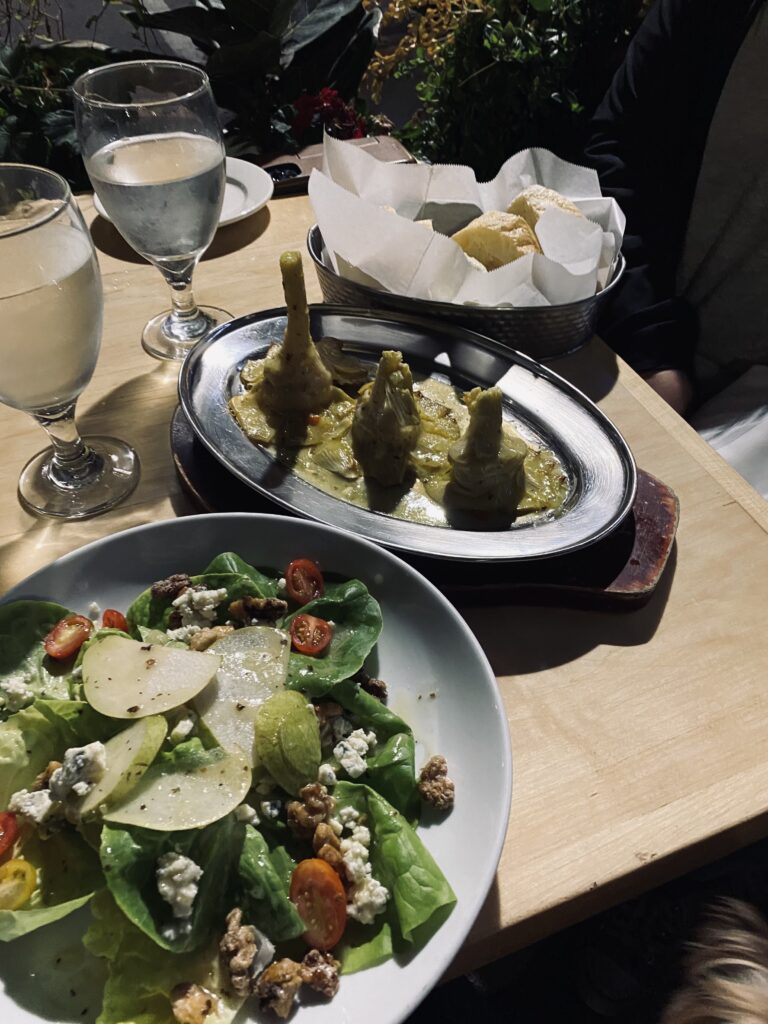 Dinner at Allegro. Plated a salad with walnuts, pears, and goat cheese. Grilled artichokes and a basket of bread.