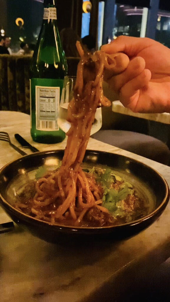 SPICY CUMIN LAMB NOODLE lamb ragu, parmesan, cilantro breadcrumbs