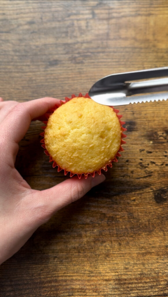 Yellow cupcake with Peeler. Getting ready to cut out the center of the cupcake.