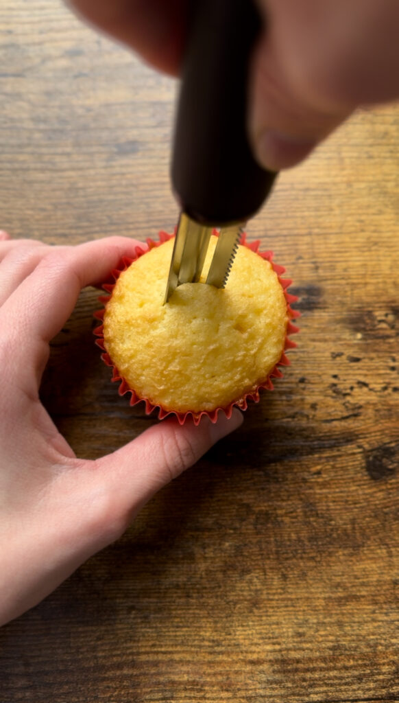 Cutting out the center of a cupcake.