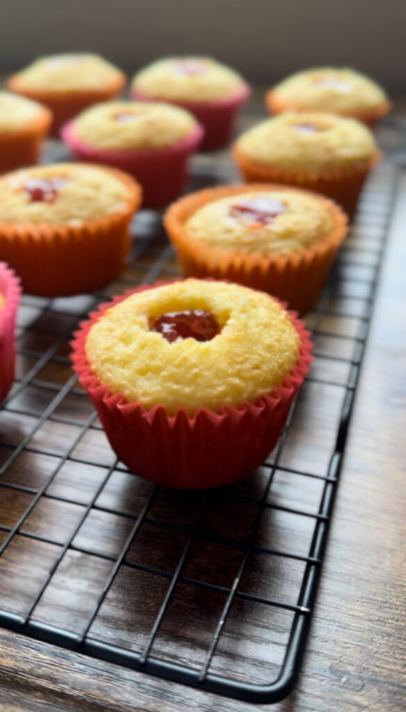 Yellow cupcake with strawberry center.