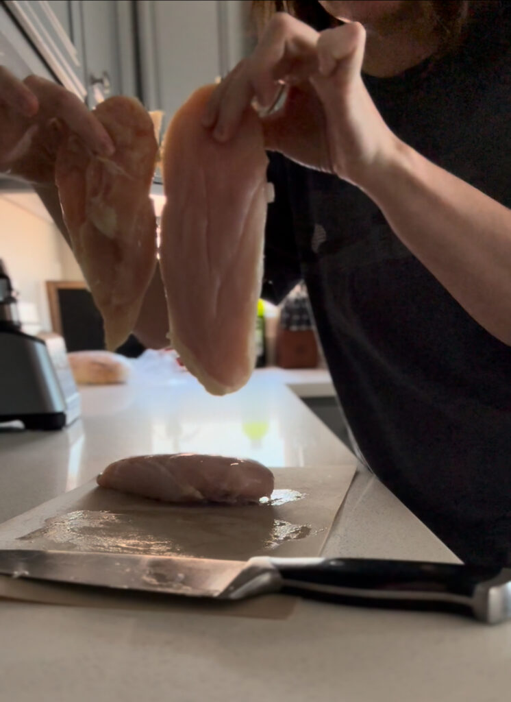 raw chicken breast sliced in half for chicken paprikash