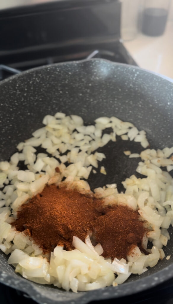 diced onion in frying pan with butter and paprika for chicken paprikash