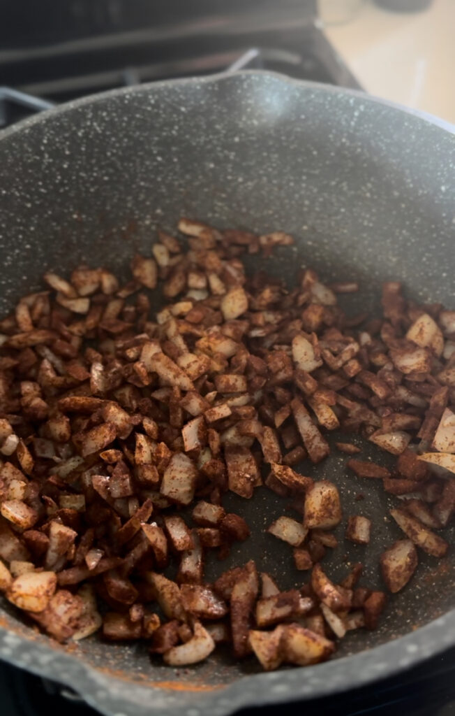 diced onion in frying pan with butter and paprika for chicken paprikash