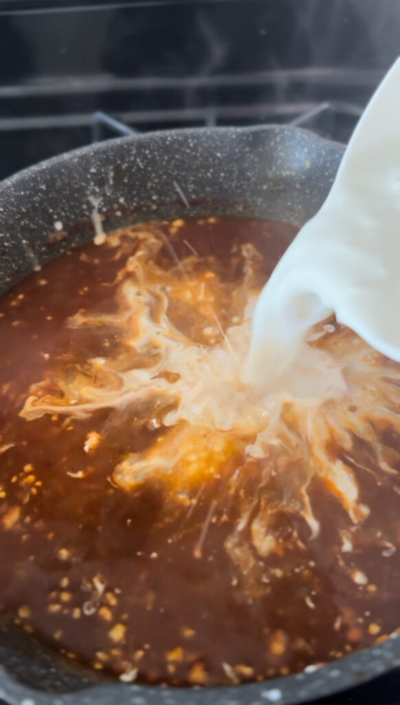 adding sour cream mixture to the broth