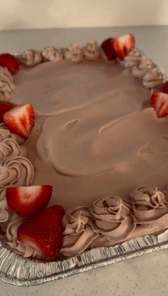 Garnishing cake with strawberries and cherries