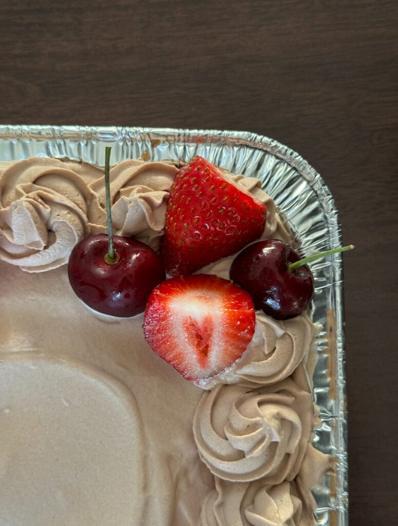 Cherries and strawberries on cake