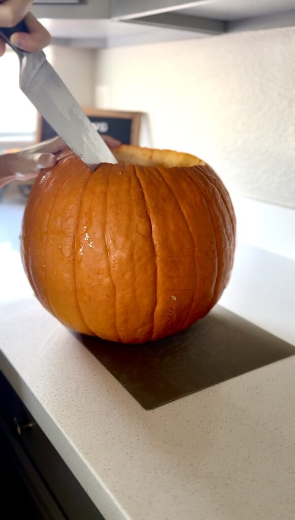 cutting into the carving pumpkin for pumpkin puree