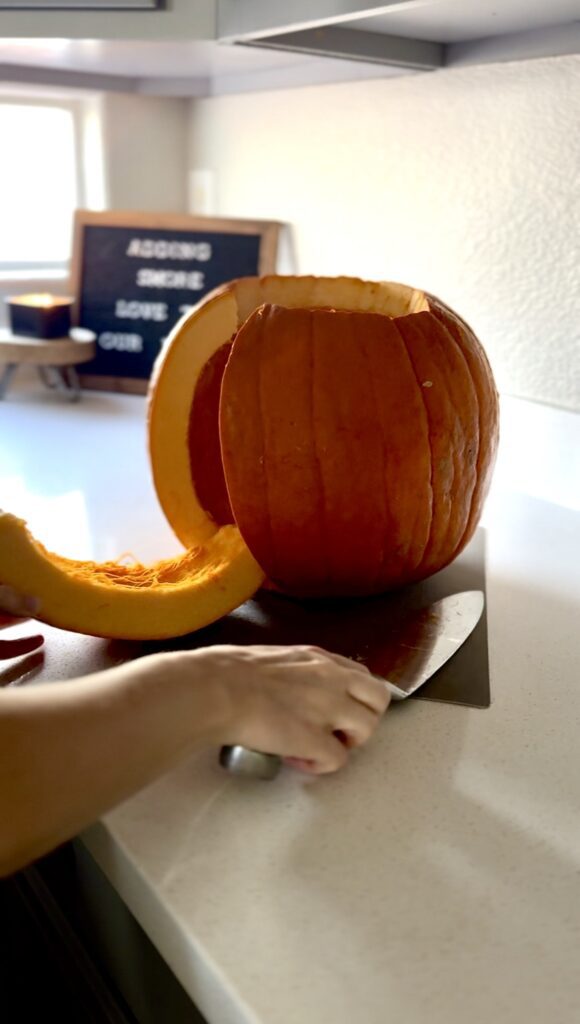 cutting into the carving pumpkin for pumpkin puree