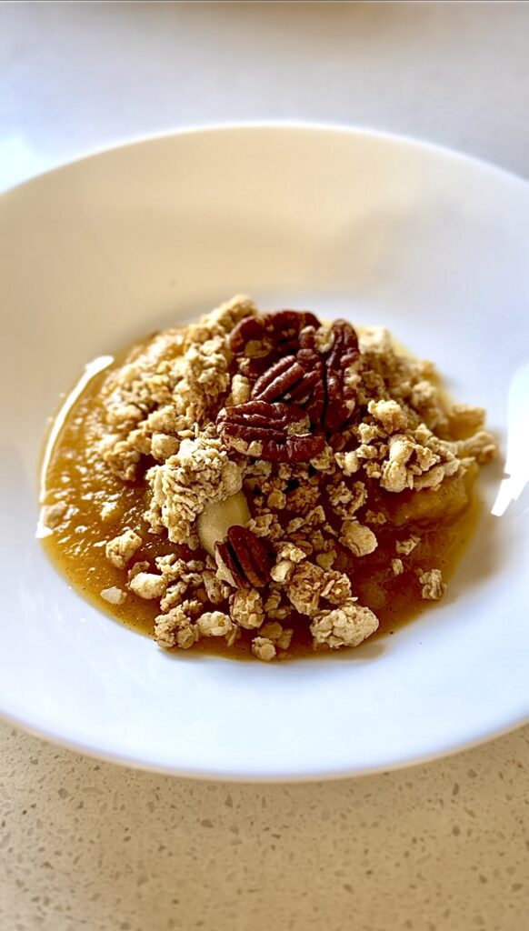 Pumpkin puree with granola and pecans on top.