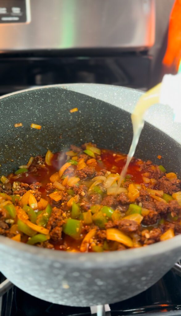 adding chicken broth for Sopa De Chorizo Con Papas: Chorizo and Potato Soup