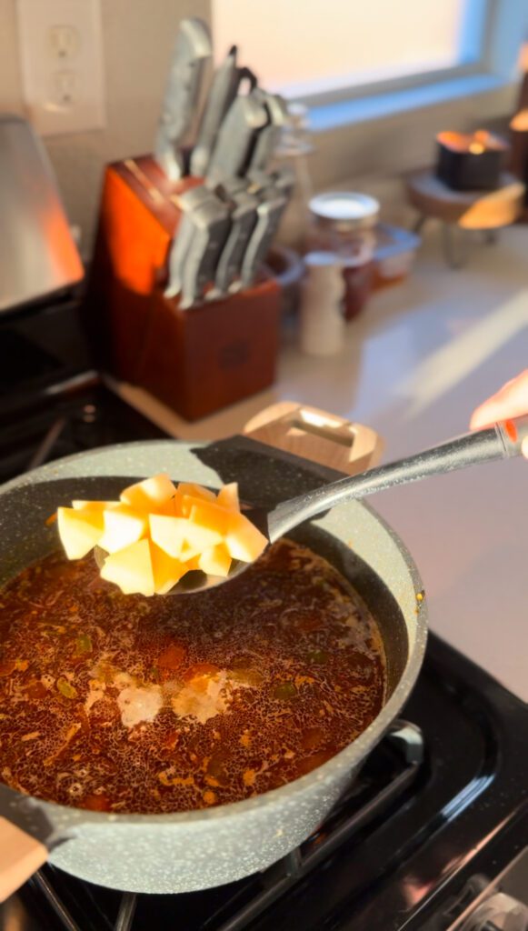 adding potatos for Sopa De Chorizo Con Papas: Chorizo and Potato Soup