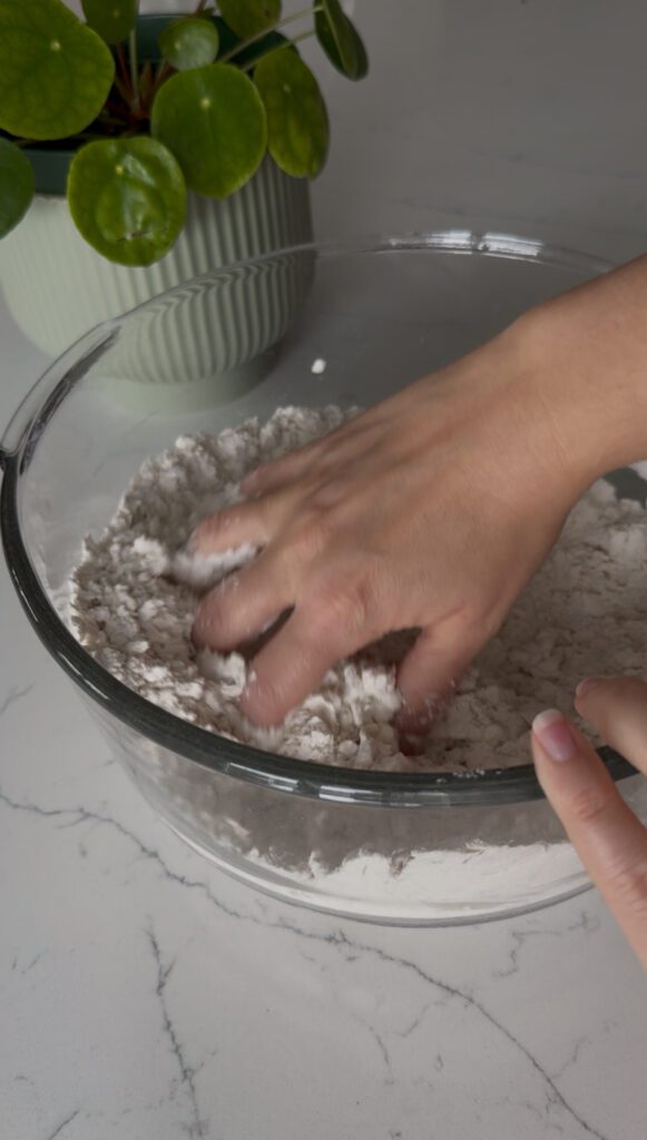 Homemade Udon Noodles -pour water in slowly and mix with hands