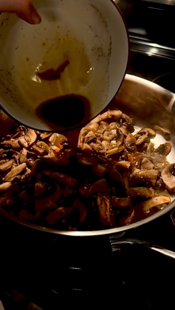Deglazing the sautéed mushrooms