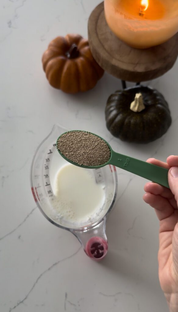 Dry yeast being added to warm milk for conchas