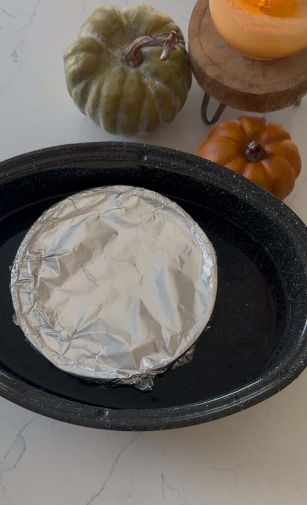flan covered in foil ready to be baked