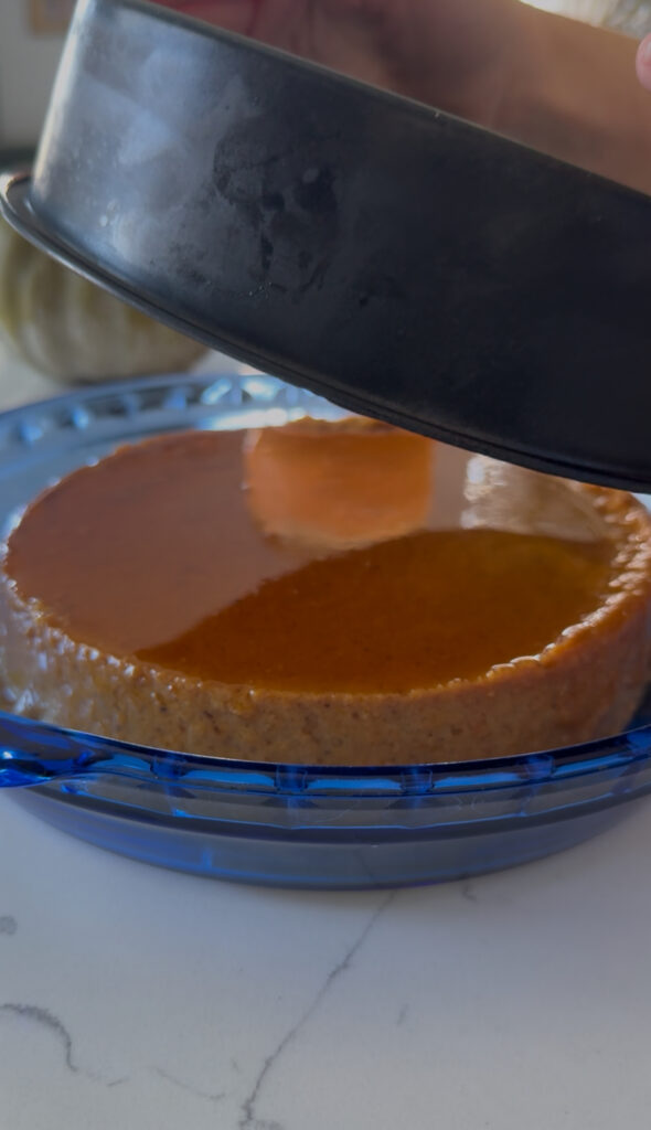 Flipping the cooled pumpkin flan upside down to serve