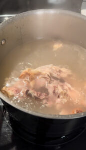 Water-covered chicken bones bring to a boil
