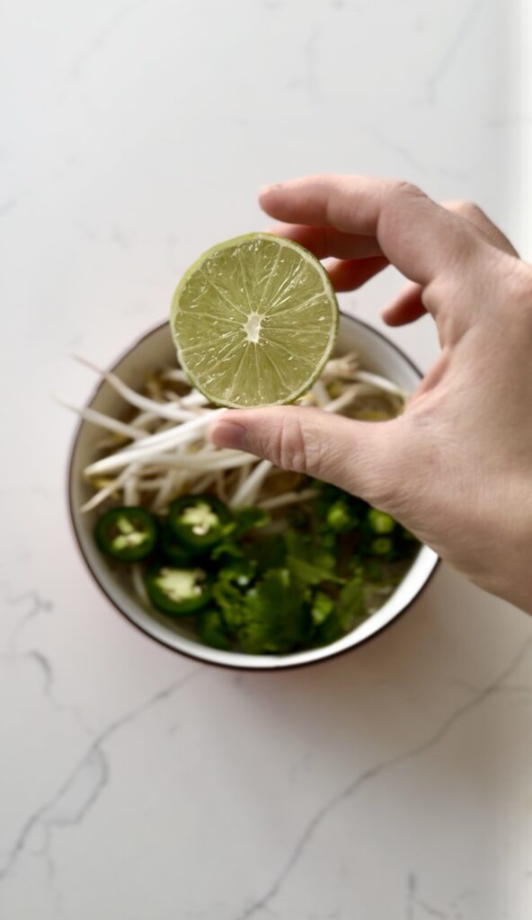 lime ready to be squeezed on chicken pho