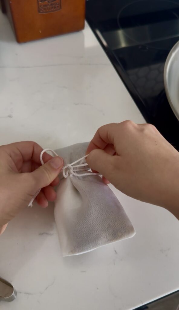 tying up the pho spice bag tightly