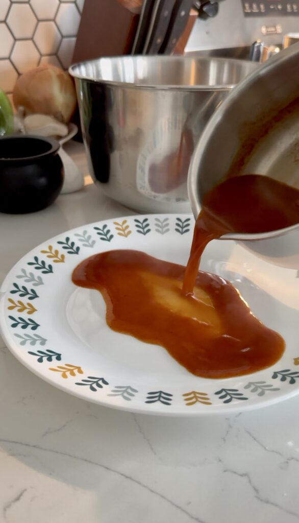 pouring red sauce on a plate