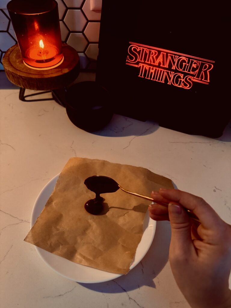 placing melted chocolate on parchment paper