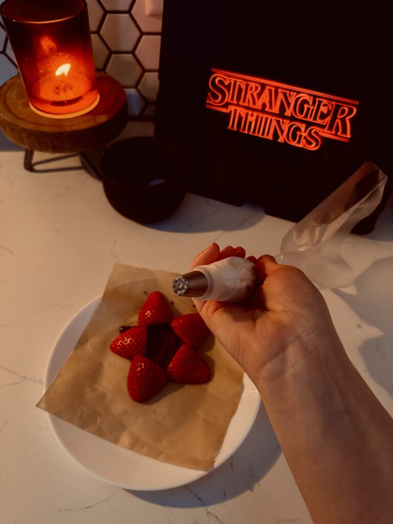 piping royal icing teeth on strawberries