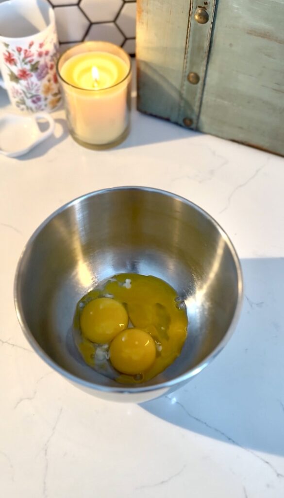 seperated three egg yolks in a bowl.
