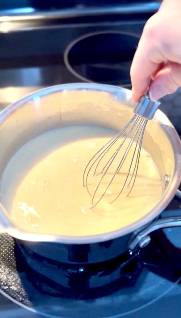 the mixture added in a pan with milk cooking on low heat