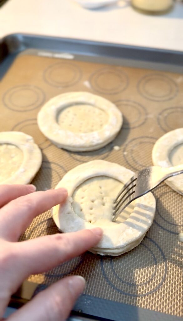 using a fork to press holes in the center