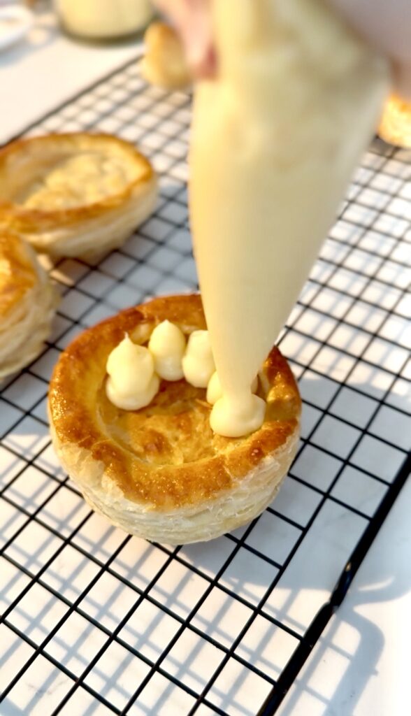 piping custard onto the puff pastry