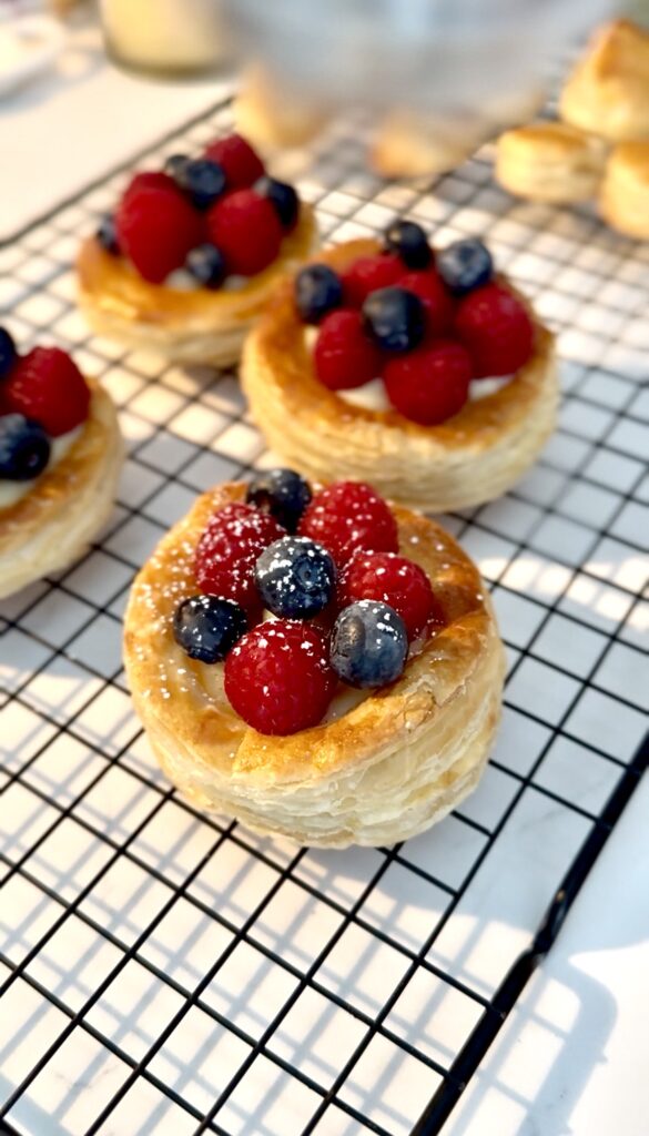 dusting the puff pastries with powdered sugar