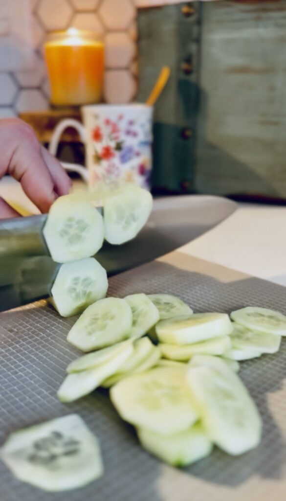 slicing an english cucumber into thin slices