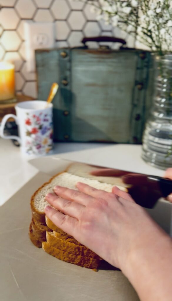 cutting the crust of the bread