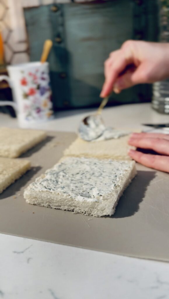 spreading the cream cheese mixture on slices of bread