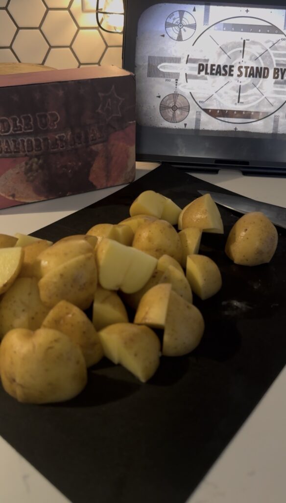 6 small potatoes cubed on a cutting board.