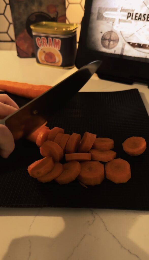Cutting a carrot into small discs with a large knife
