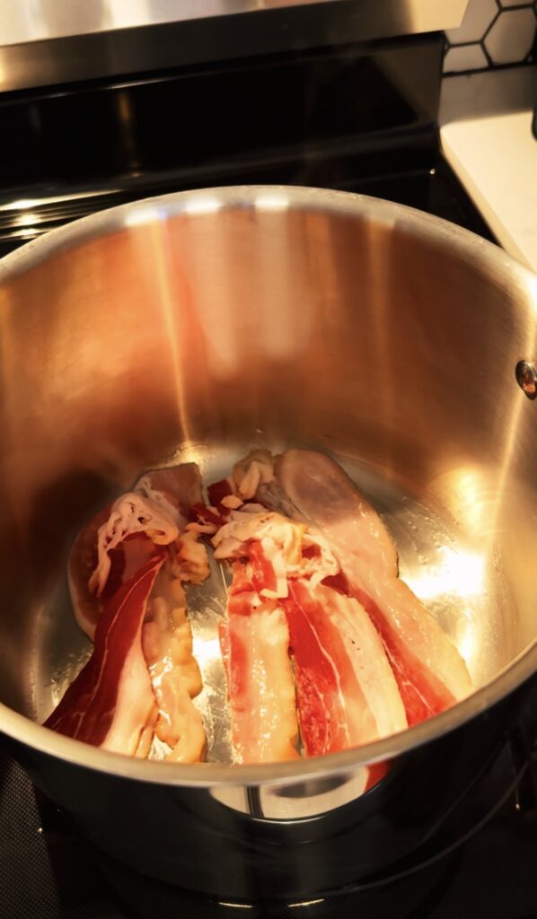 Raw bacon on the bottom of a stock pot