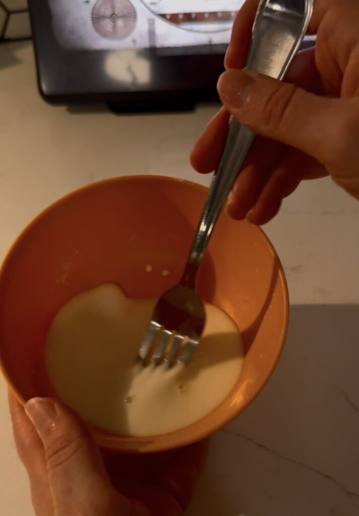 whisking the cornstarch and water in the bowl